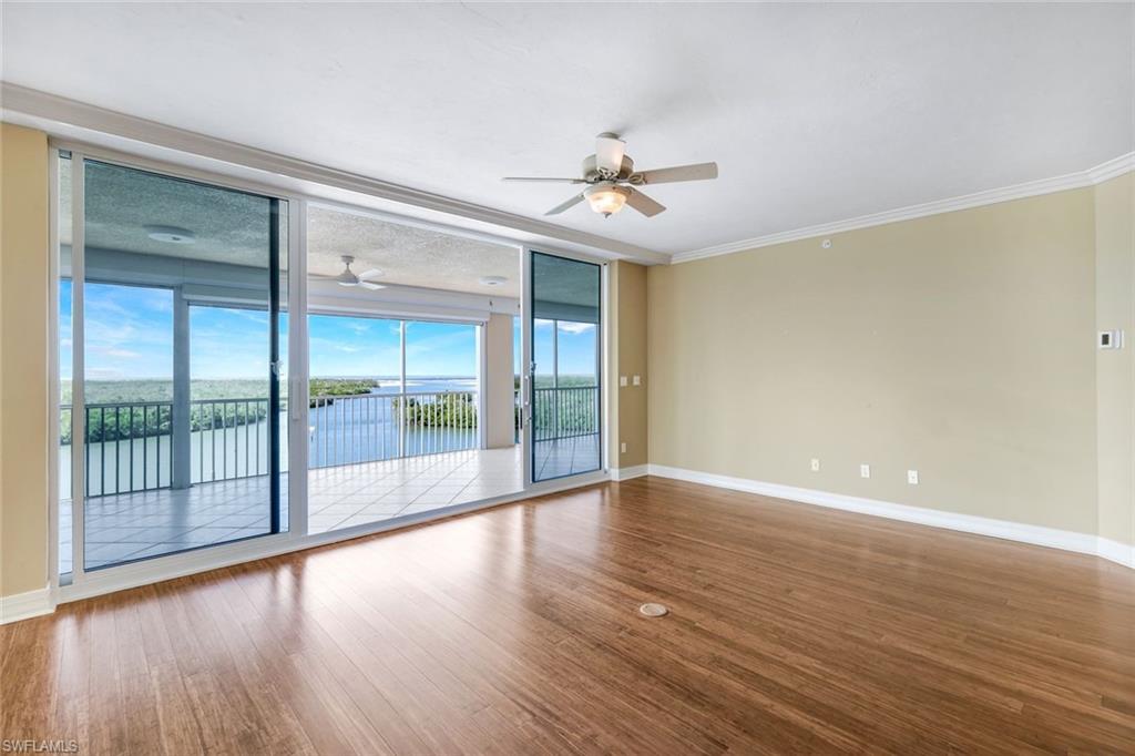425 Dockside Drive, Unit 604 Naples, FL 34110 - Photo 11 of 34 a view of empty room with wooden floor and fan