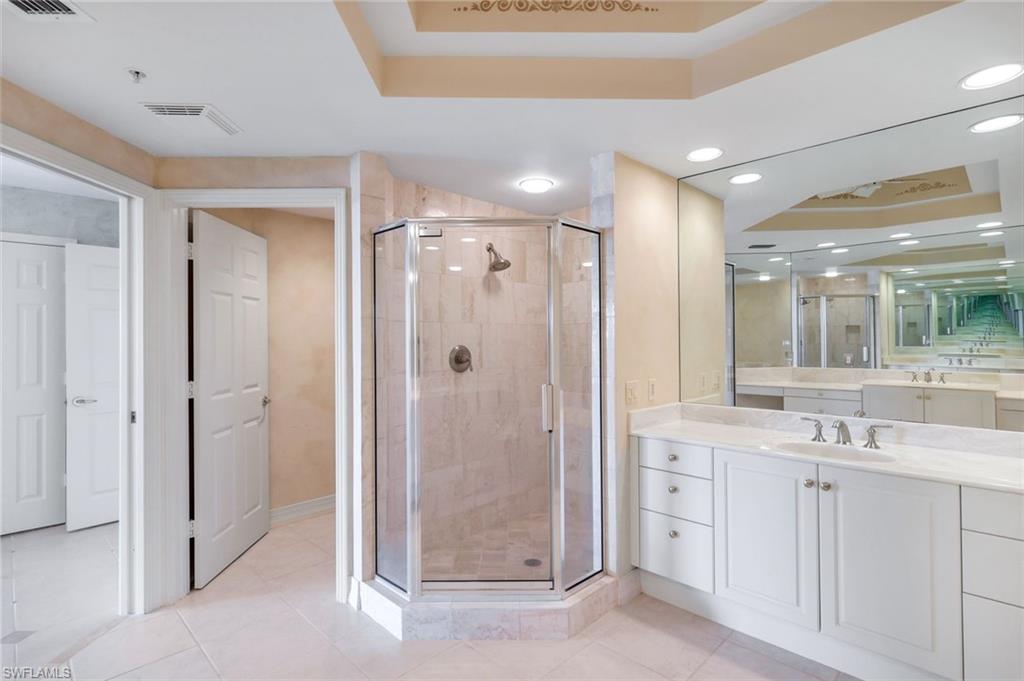 425 Dockside Drive, Unit 604 Naples, FL 34110 - Photo 18 of 34 a bathroom with a shower sink and mirror