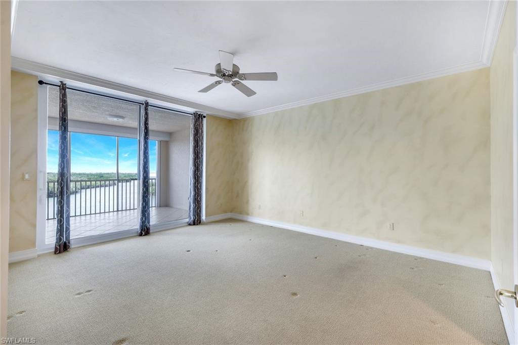 425 Dockside Drive, Unit 604 Naples, FL 34110 - Photo 20 of 34 an empty room with a ceiling fan and a window