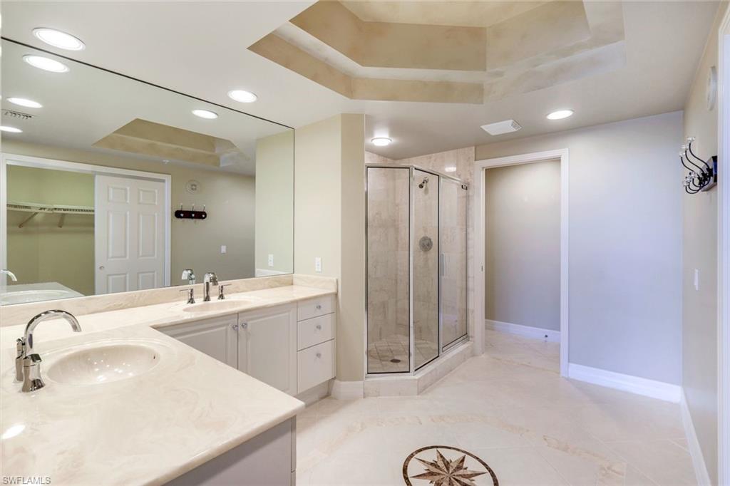 425 Dockside Drive, Unit 604 Naples, FL 34110 - Photo 21 of 34 a bathroom with a sink double vanity and a mirror