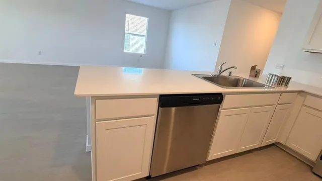 a view of an empty room and a window