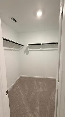 a bedroom with a bed and a night stand