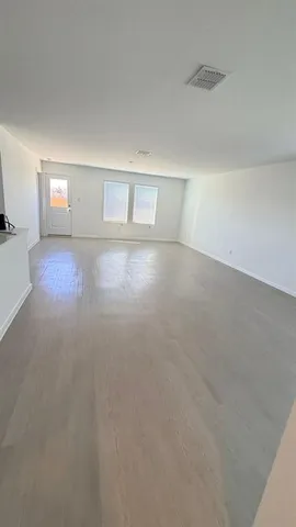 a large kitchen with stainless steel appliances and a refrigerator