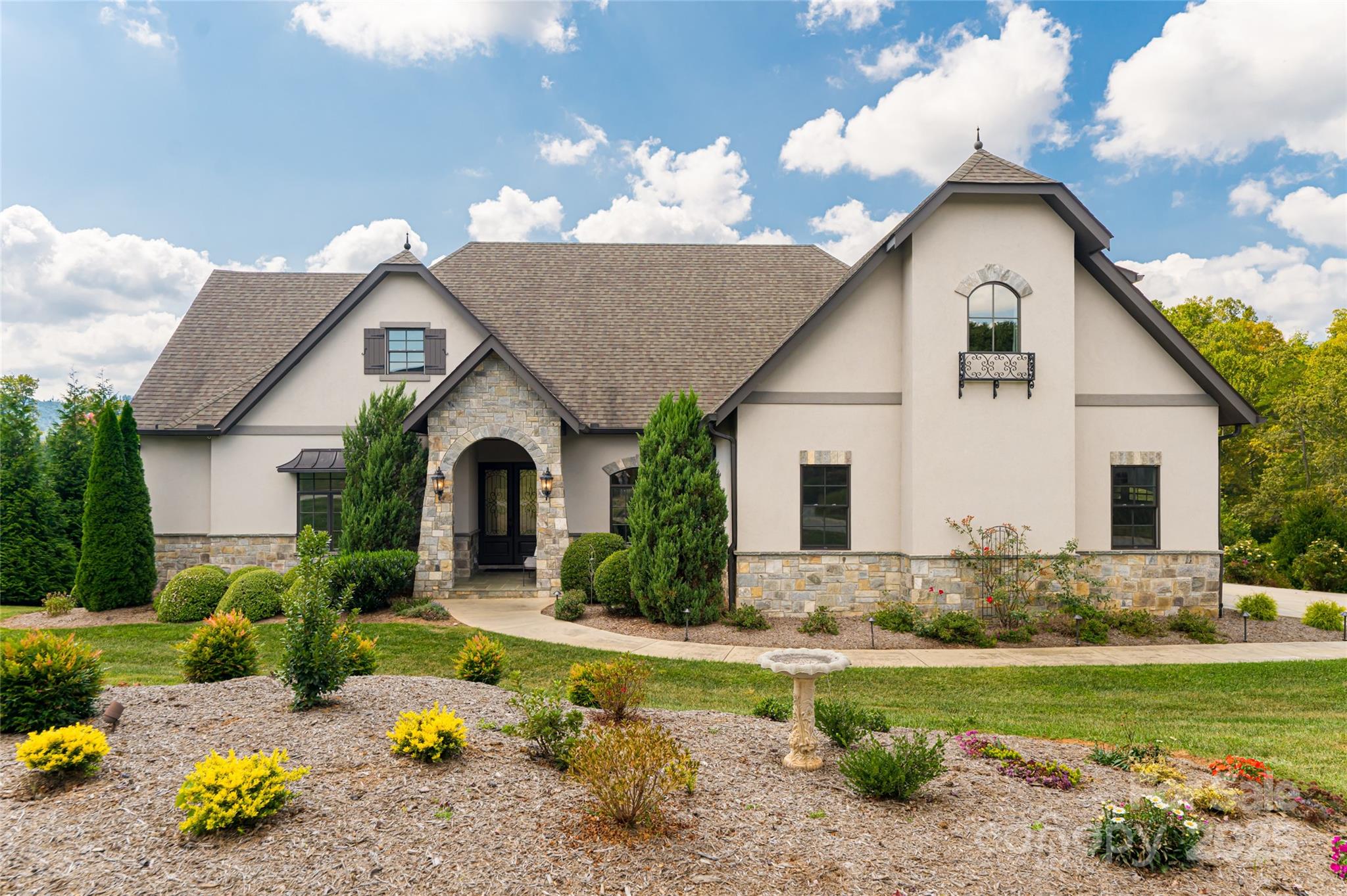 a front view of a house with garden