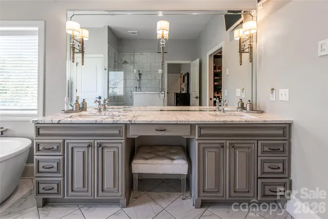 a bathroom with a granite countertop sink toilet a mirror and shower