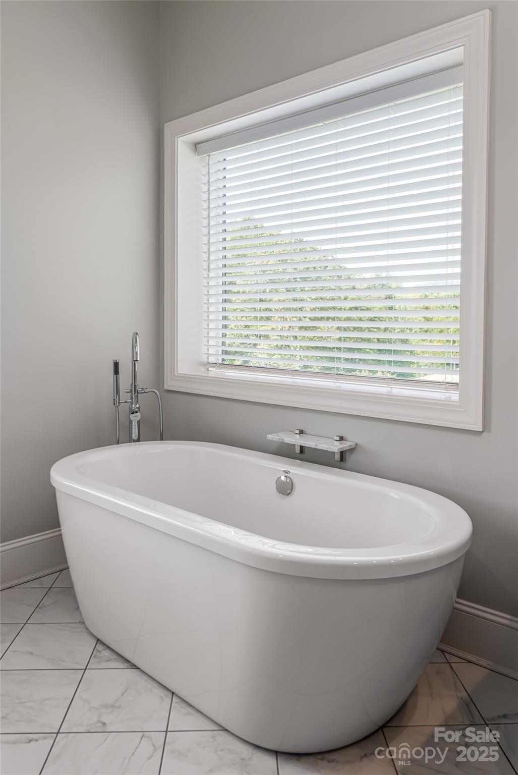 64 Waterhill Way Fletcher, NC 28732 - Photo 21 of 48 a white bath tub sitting in a bathroom next to a window