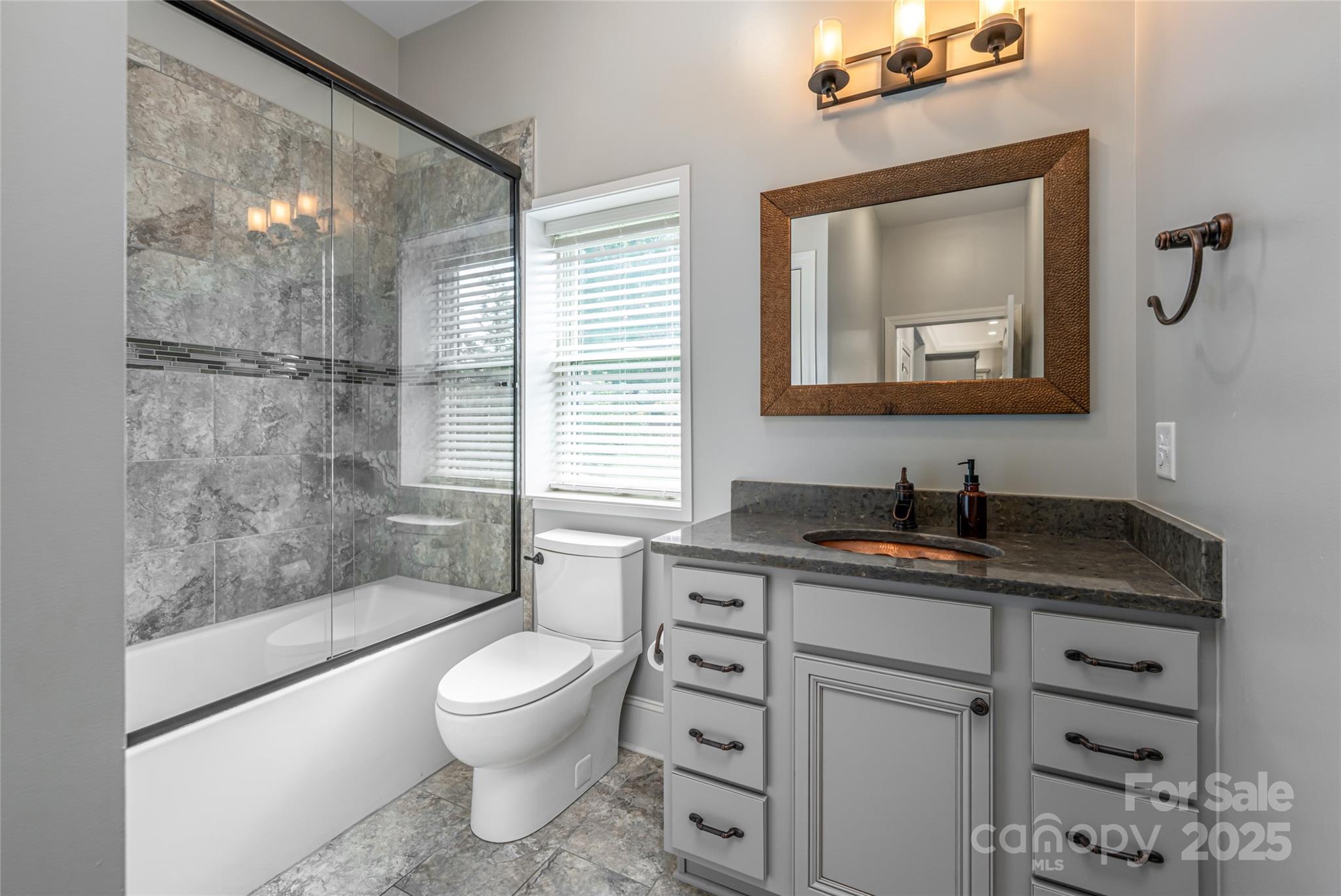 64 Waterhill Way Fletcher, NC 28732 - Photo 25 of 48 a bathroom with a granite countertop sink toilet a mirror and shower