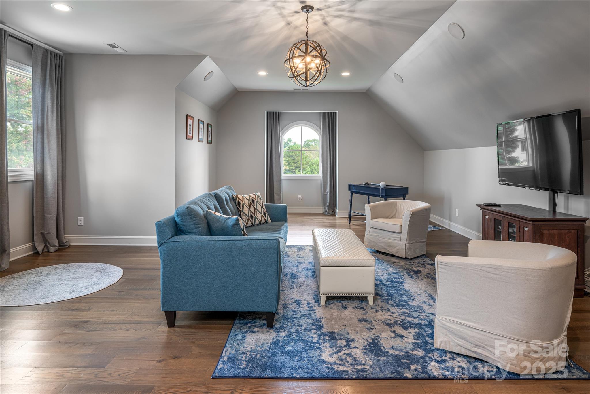64 Waterhill Way Fletcher, NC 28732 - Photo 27 of 48 a living room with furniture a dining table and a chandelier