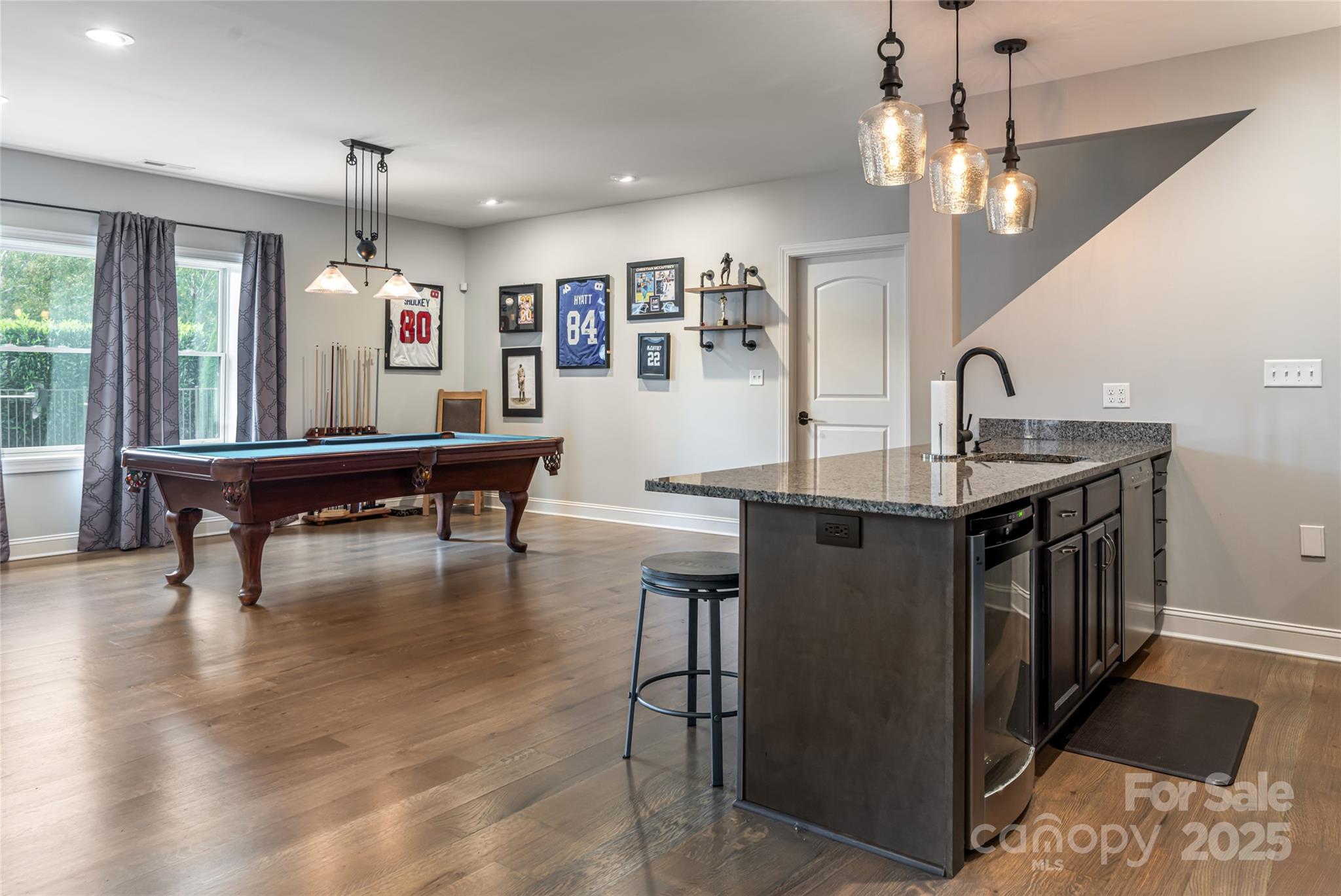 64 Waterhill Way Fletcher, NC 28732 - Photo 31 of 48 a living room with kitchen island furniture a chandelier and a large window
