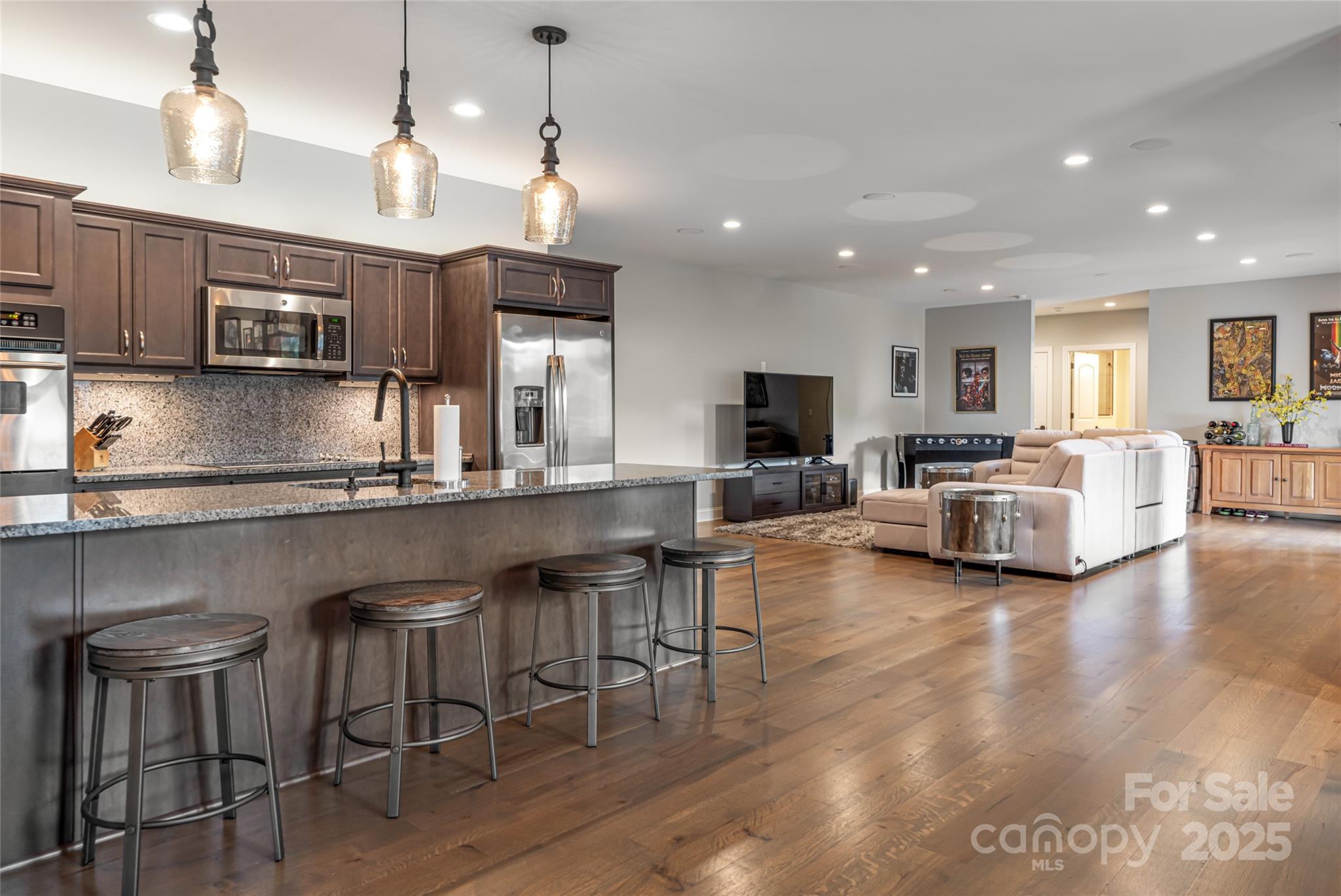 64 Waterhill Way Fletcher, NC 28732 - Photo 33 of 48 a kitchen with stainless steel appliances granite countertop a stove top oven a sink dishwasher a dining table and chairs with wooden floor