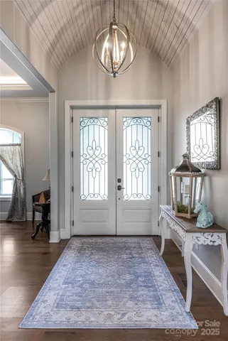 wooden floor with chandelier