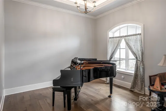 a living room with a piano and a window