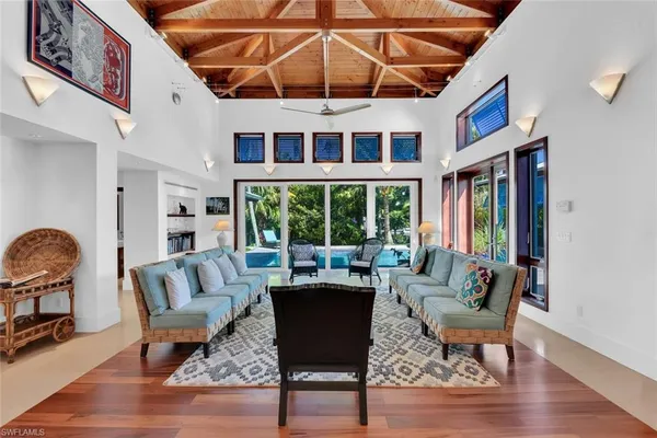 a living room with furniture a rug and a large window