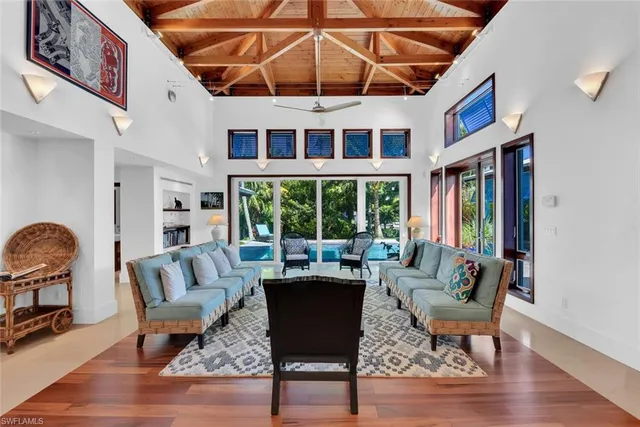 a living room with furniture a rug and a large window
