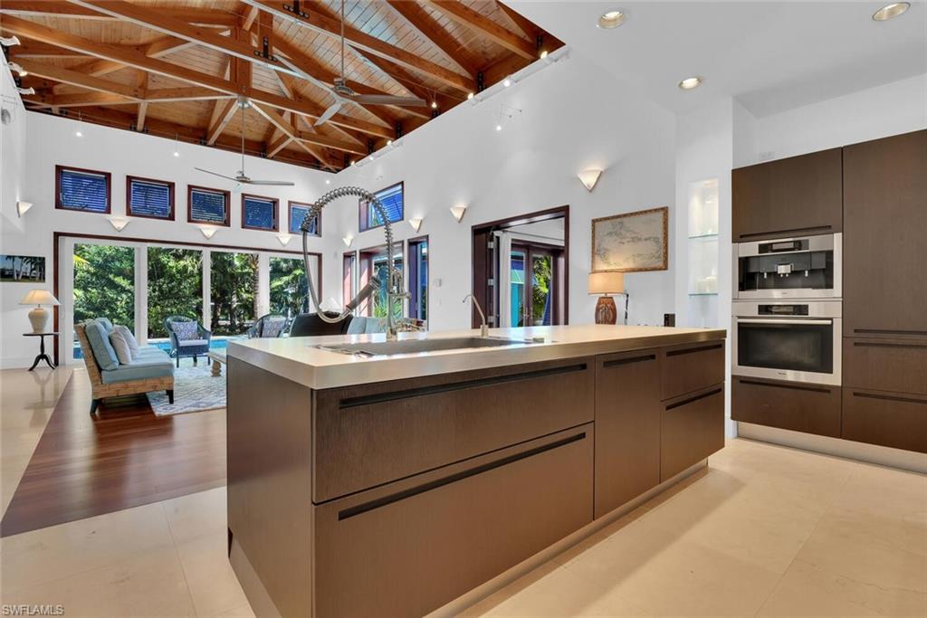 795 18th Avenue South Naples, FL 34102 - Photo 11 of 48 a kitchen with stainless steel appliances granite countertop a stove and a refrigerator