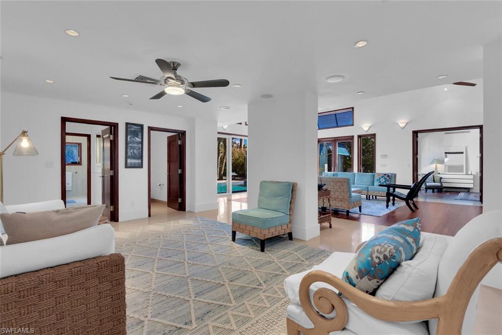 795 18th Avenue South Naples, FL 34102 - Photo 17 of 48 a living room with furniture and a chandelier