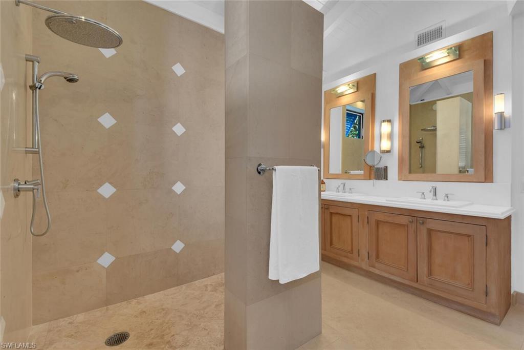 795 18th Avenue South Naples, FL 34102 - Photo 25 of 48 a bathroom with a double vanity sink a mirror and a shower