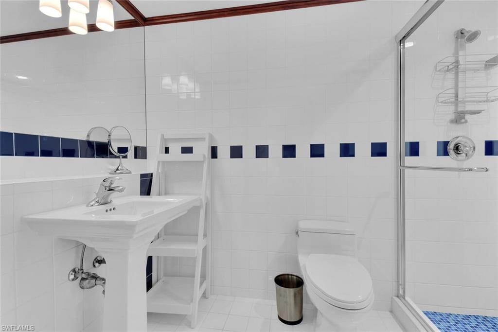 795 18th Avenue South Naples, FL 34102 - Photo 28 of 48 a bathroom with a sink a toilet and a mirror