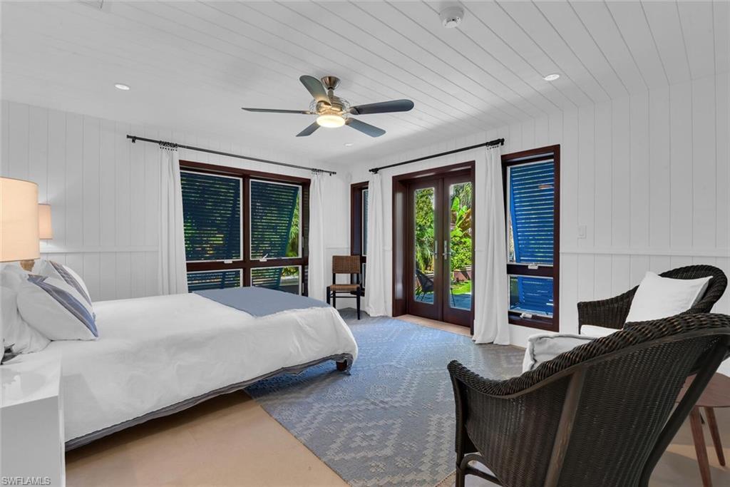 795 18th Avenue South Naples, FL 34102 - Photo 31 of 48 a bedroom with a large bed and a large window