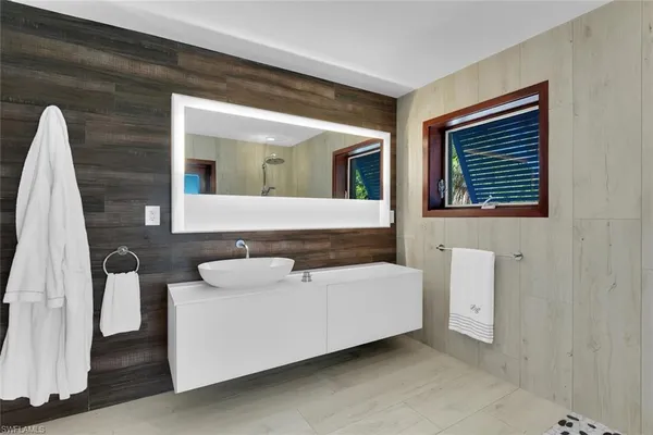a bathroom with a toilet a sink and a mirror