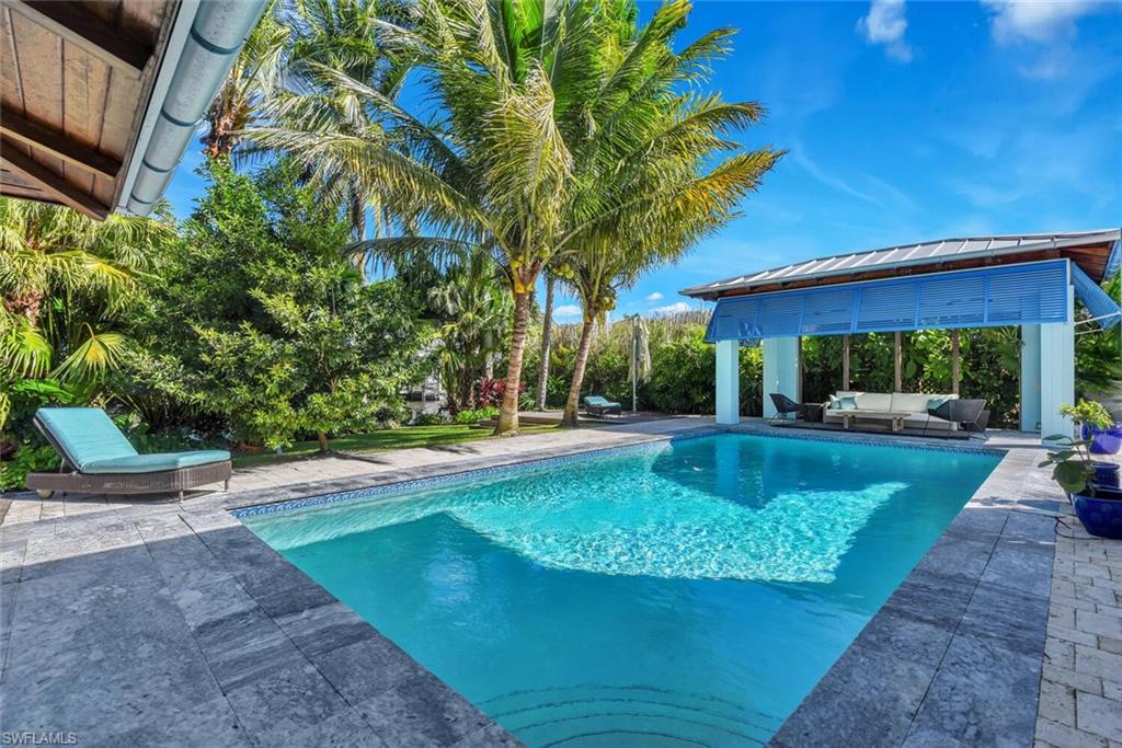 795 18th Avenue South Naples, FL 34102 - Photo 36 of 48 a view of backyard with swimming pool and outdoor seating
