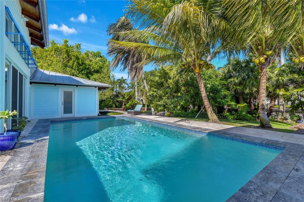 795 18th Avenue South Naples, FL 34102 - Photo 38 of 48 a view of a backyard with plants and palm trees
