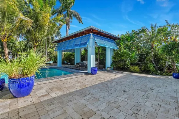 a view of patio with swimming pool table and chairs