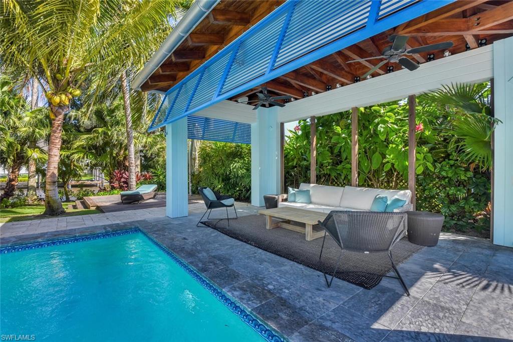 795 18th Avenue South Naples, FL 34102 - Photo 41 of 48 a view of patio with swimming pool table and chairs