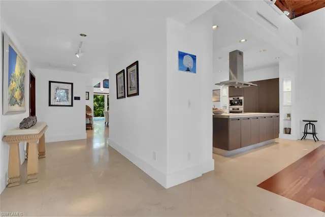 a view of a kitchen with furniture and wooden floor