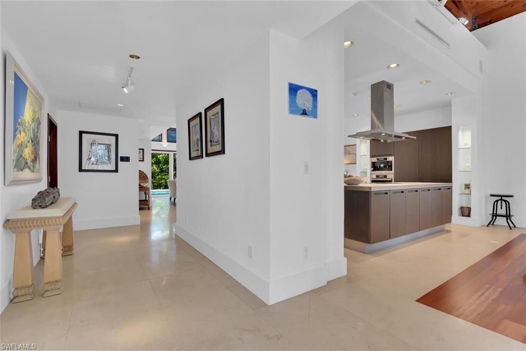 795 18th Avenue South Naples, FL 34102 - Photo 5 of 48 a view of a kitchen with furniture and wooden floor