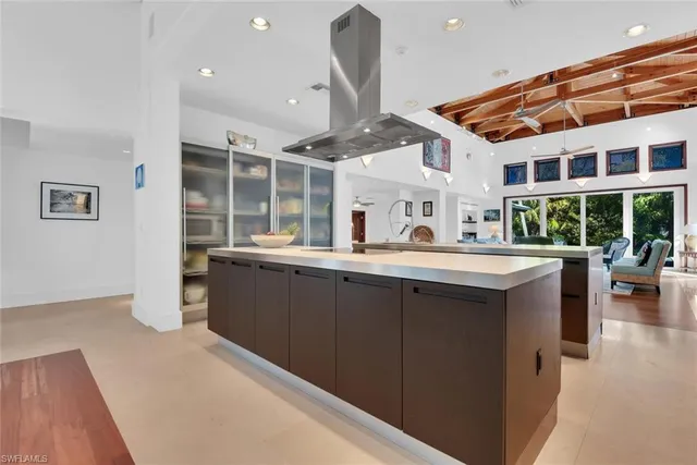 a kitchen with stainless steel appliances granite countertop a sink and a large window