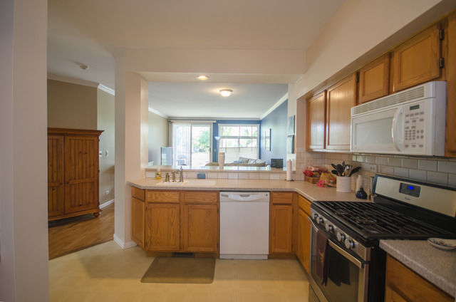 963 Ripple Ridge Cove, Unit 963 Darien, IL 60561 - Photo 7 of 15 a kitchen with a stove and a sink
