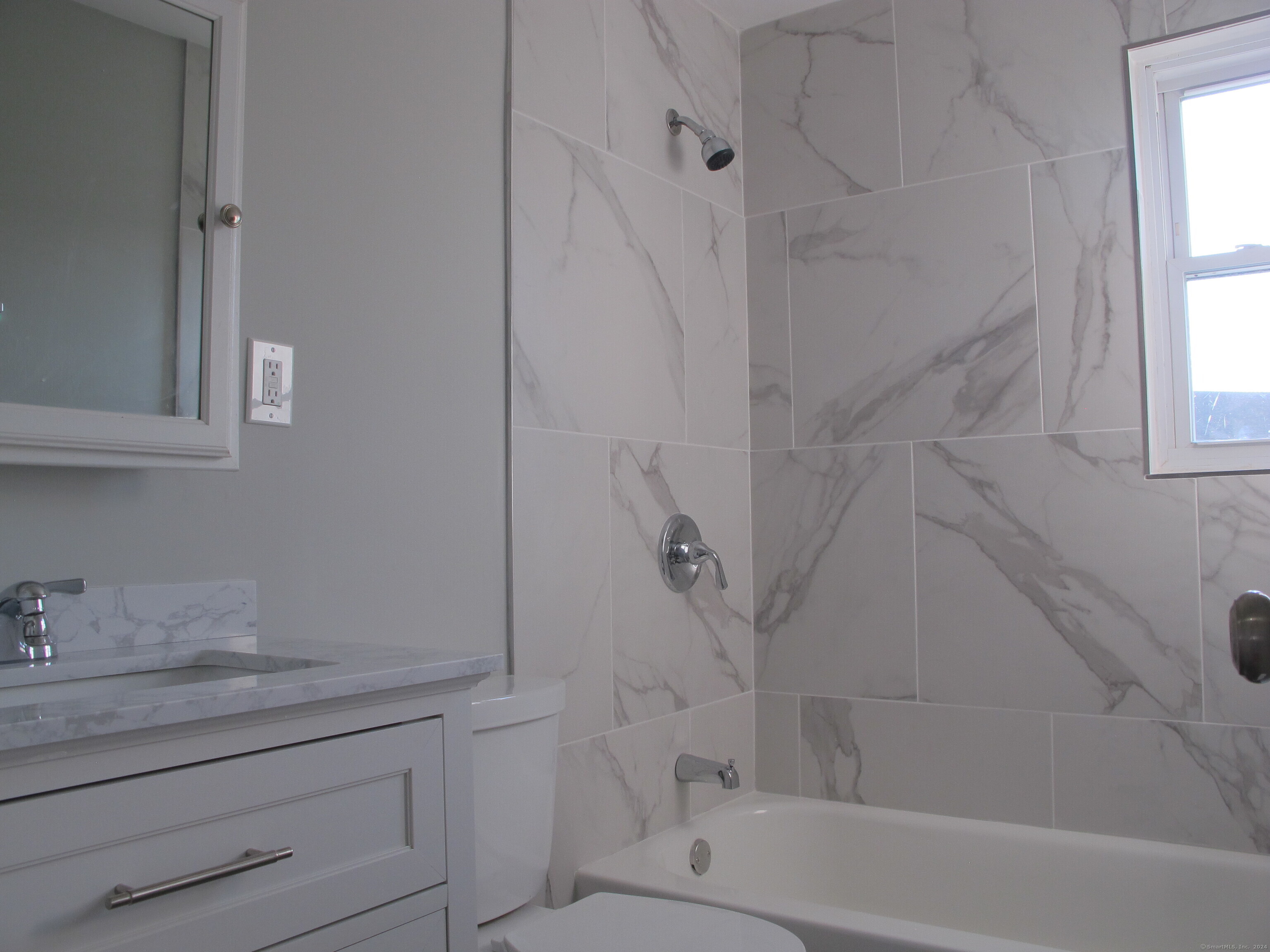 175 Seaton Road, Unit 3 Stamford, CT 06902 - Photo 2 of 14 a bathroom with a shower toilet and sink