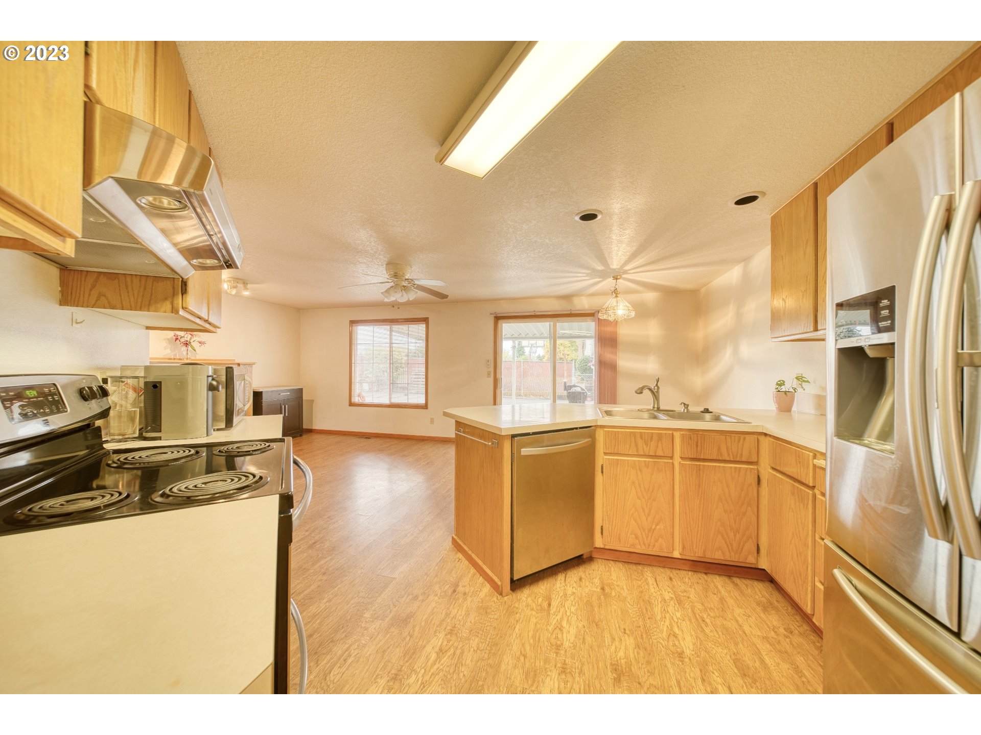 33912 Southeast Everett Way Scappoose, OR 97056 - Photo 11 of 32 a kitchen with stainless steel appliances granite countertop a stove a sink and a refrigerator
