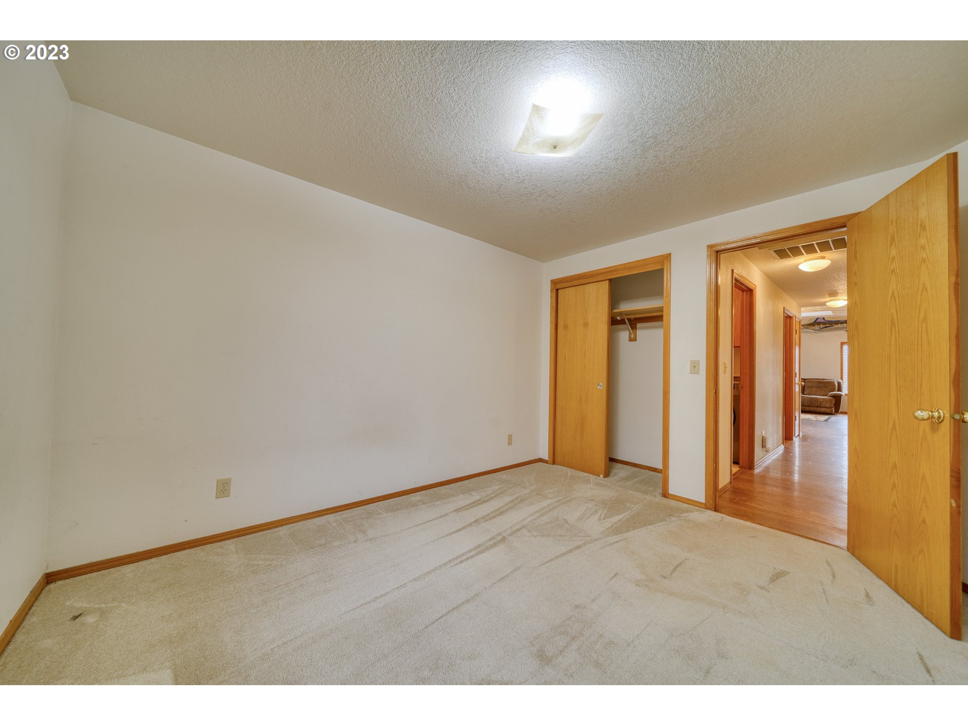 33912 Southeast Everett Way Scappoose, OR 97056 - Photo 15 of 32 a view of an empty room and wooden floor