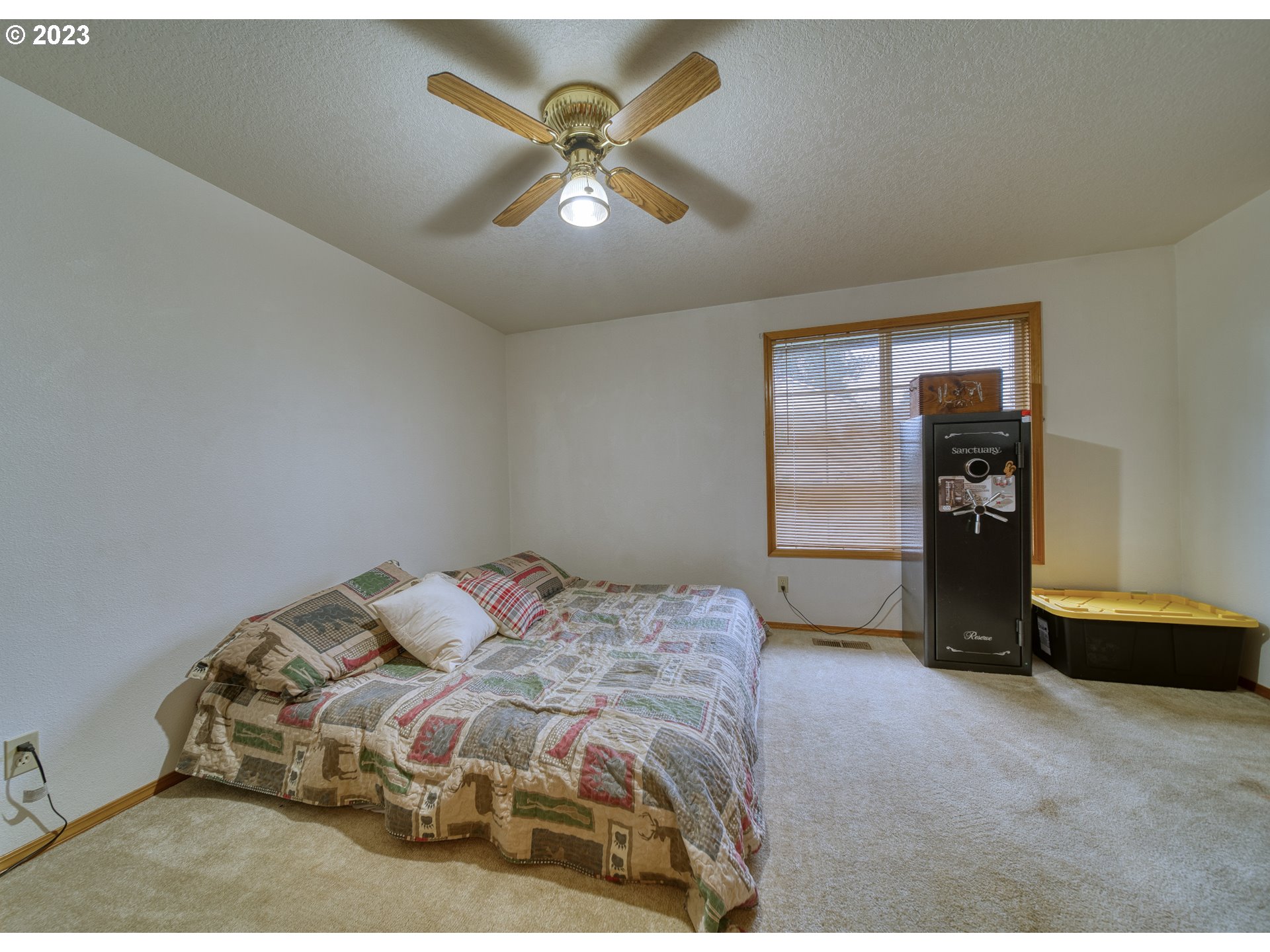33912 Southeast Everett Way Scappoose, OR 97056 - Photo 17 of 32 a bedroom with a bed and a ceiling fan