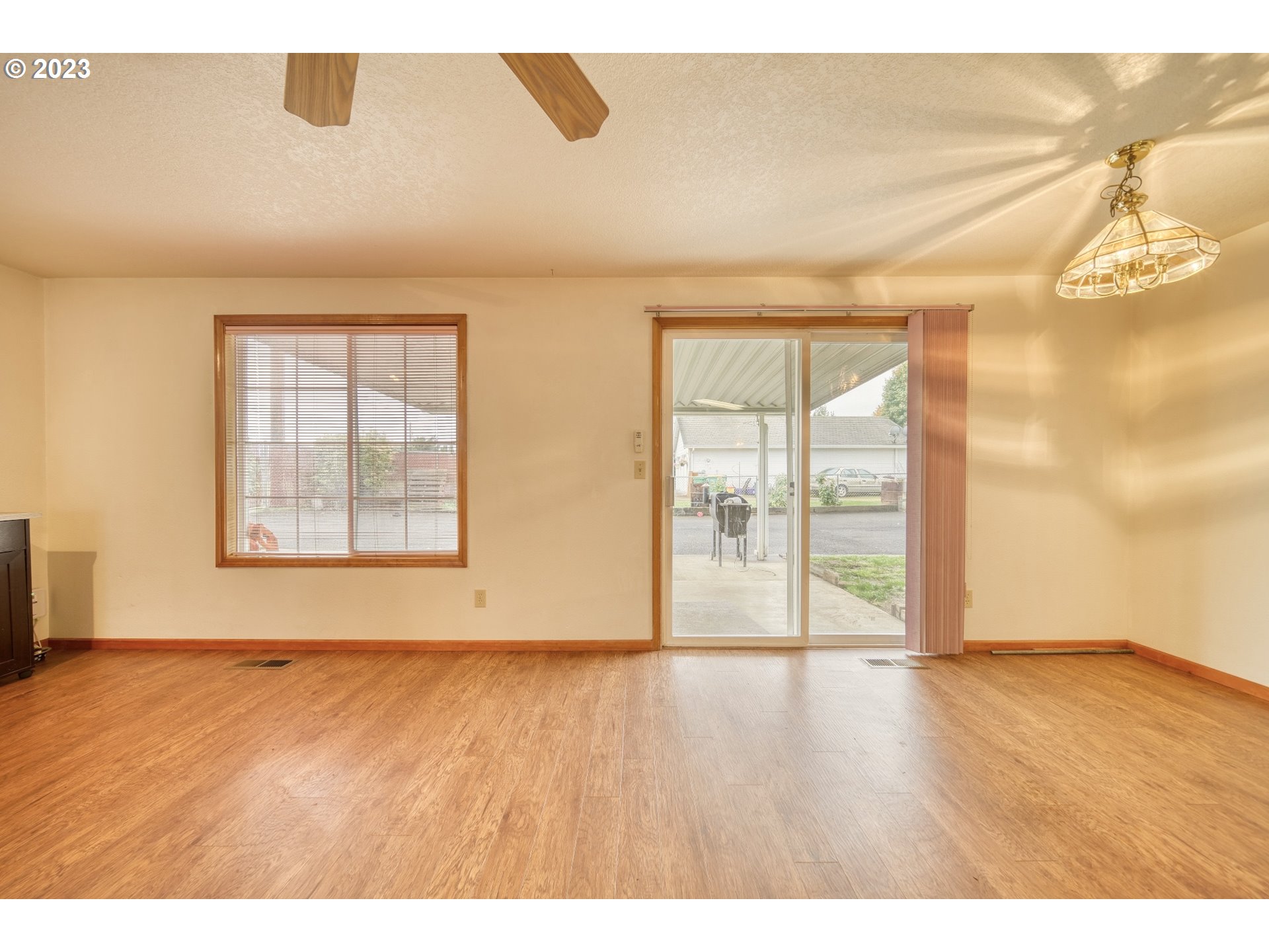 33912 Southeast Everett Way Scappoose, OR 97056 - Photo 8 of 32 an empty room with wooden floor and windows