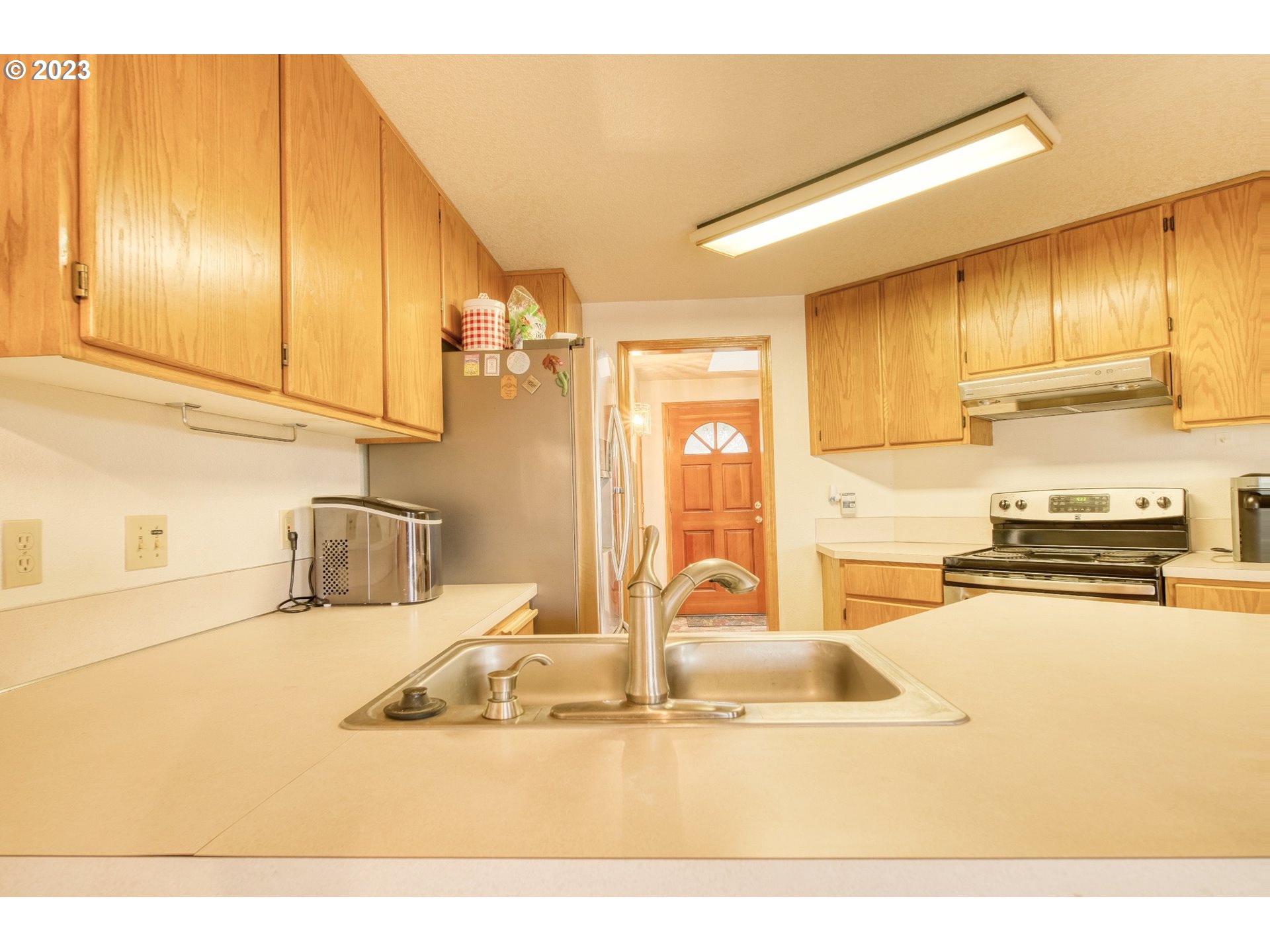 33912 Southeast Everett Way Scappoose, OR 97056 - Photo 10 of 32 a kitchen with stainless steel appliances granite countertop a sink and cabinets