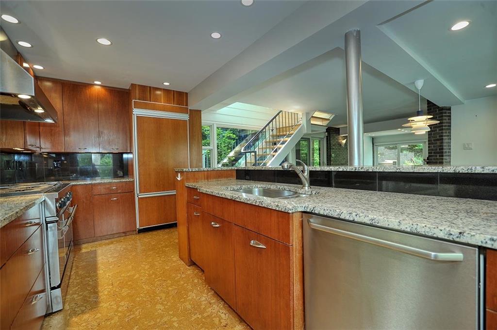90 East Woodland Road Pittsburgh, PA 15232 - Photo 14 of 27 a kitchen with stainless steel appliances granite countertop a sink a counter top space and cabinets