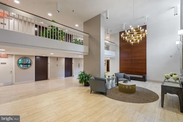 a hallway with a couch and a potted plant