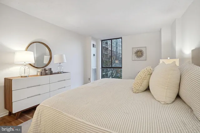 a bedroom with a large bed and a dresser