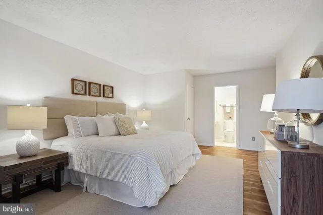 a bedroom with a bed and a lamp on table