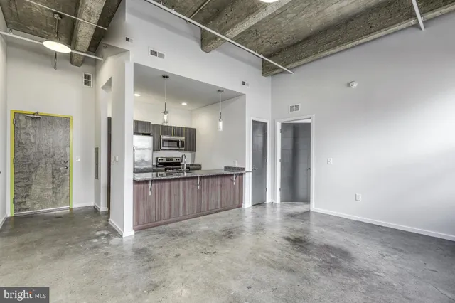 a view of kitchen with refrigerator and window