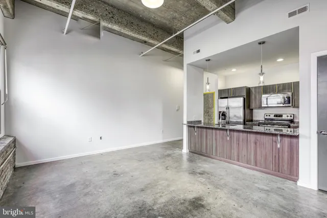 a kitchen with stainless steel appliances a refrigerator and microwave