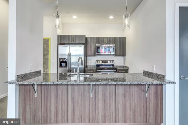 a kitchen with stainless steel appliances granite countertop a sink and a granite counter tops