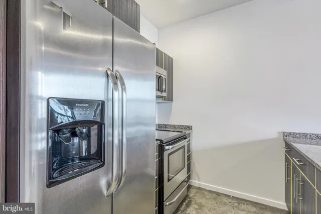 a metallic refrigerator freezer sitting in a kitchen