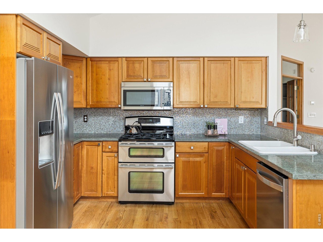 3966 Promontory Court Boulder, CO 80304 - Photo 12 of 42 a kitchen with stainless steel appliances granite countertop a refrigerator stove and sink