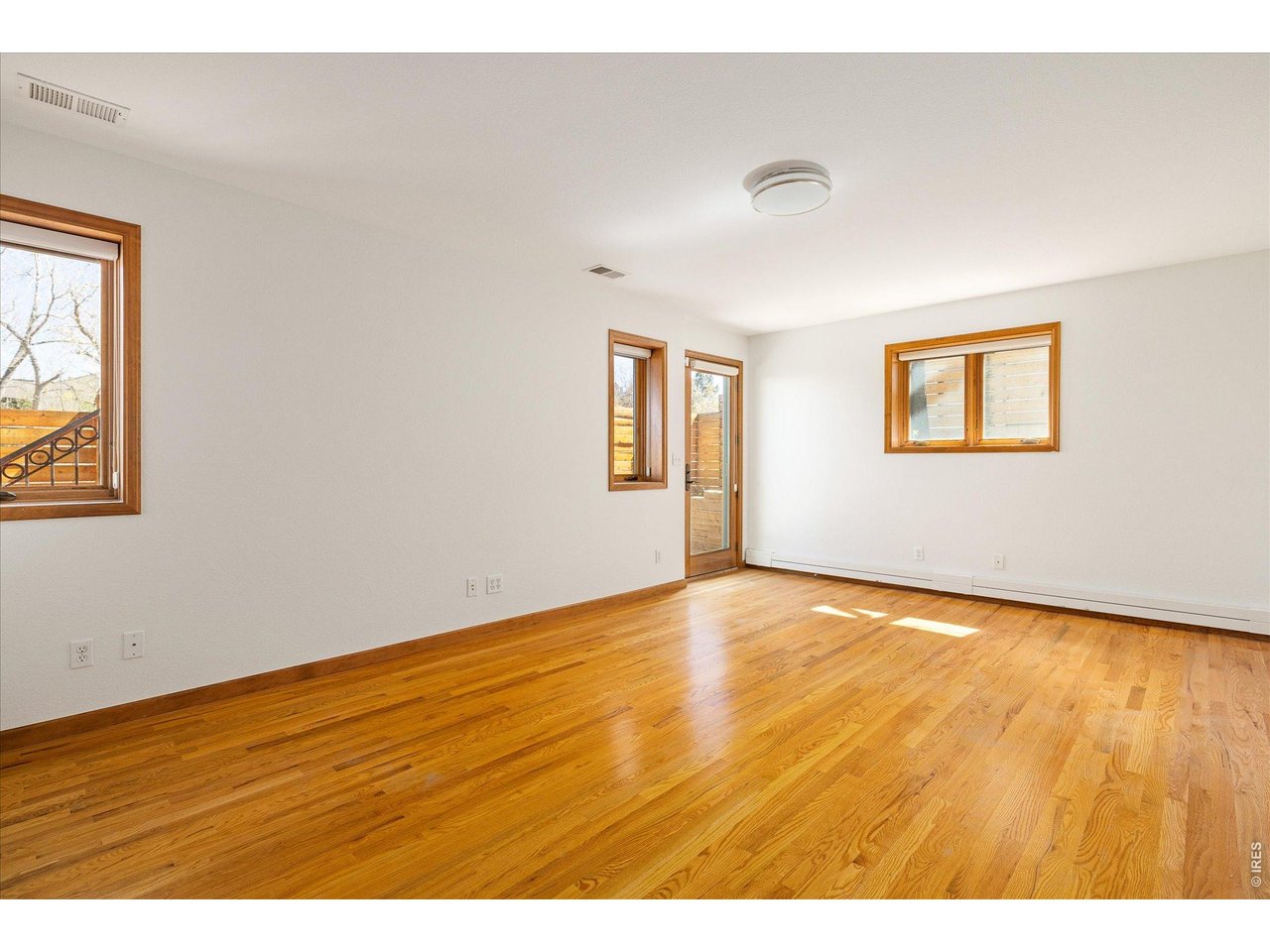 3966 Promontory Court Boulder, CO 80304 - Photo 25 of 42 a view of an empty room with wooden floor and a window
