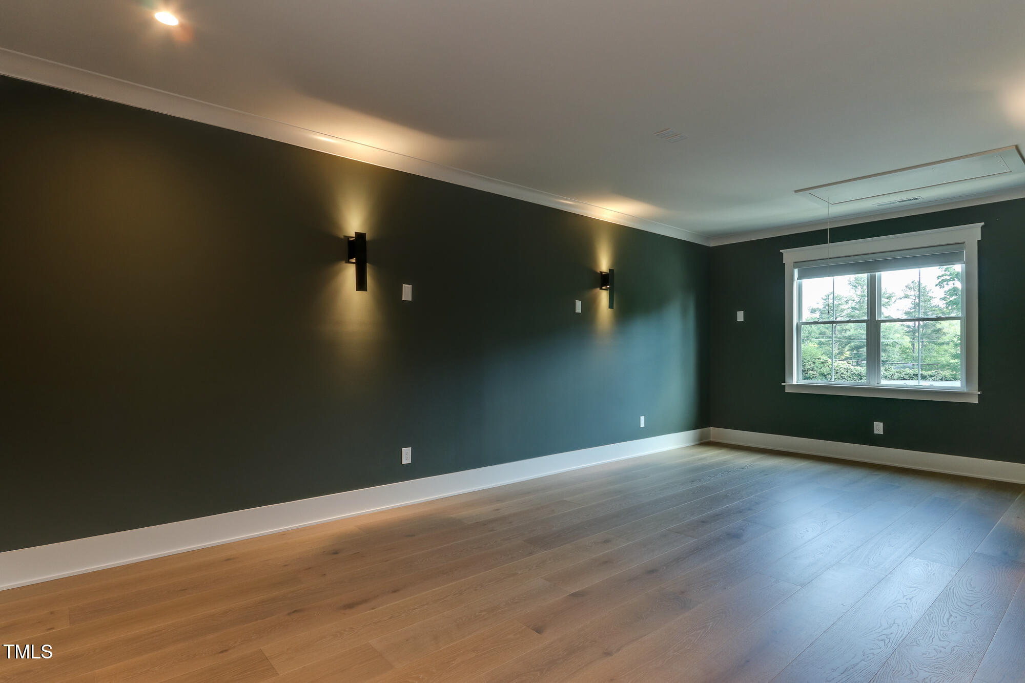 4921 Sweetbriar Drive Raleigh, NC 27609 - Photo 22 of 42 an empty room with wooden floor and windows