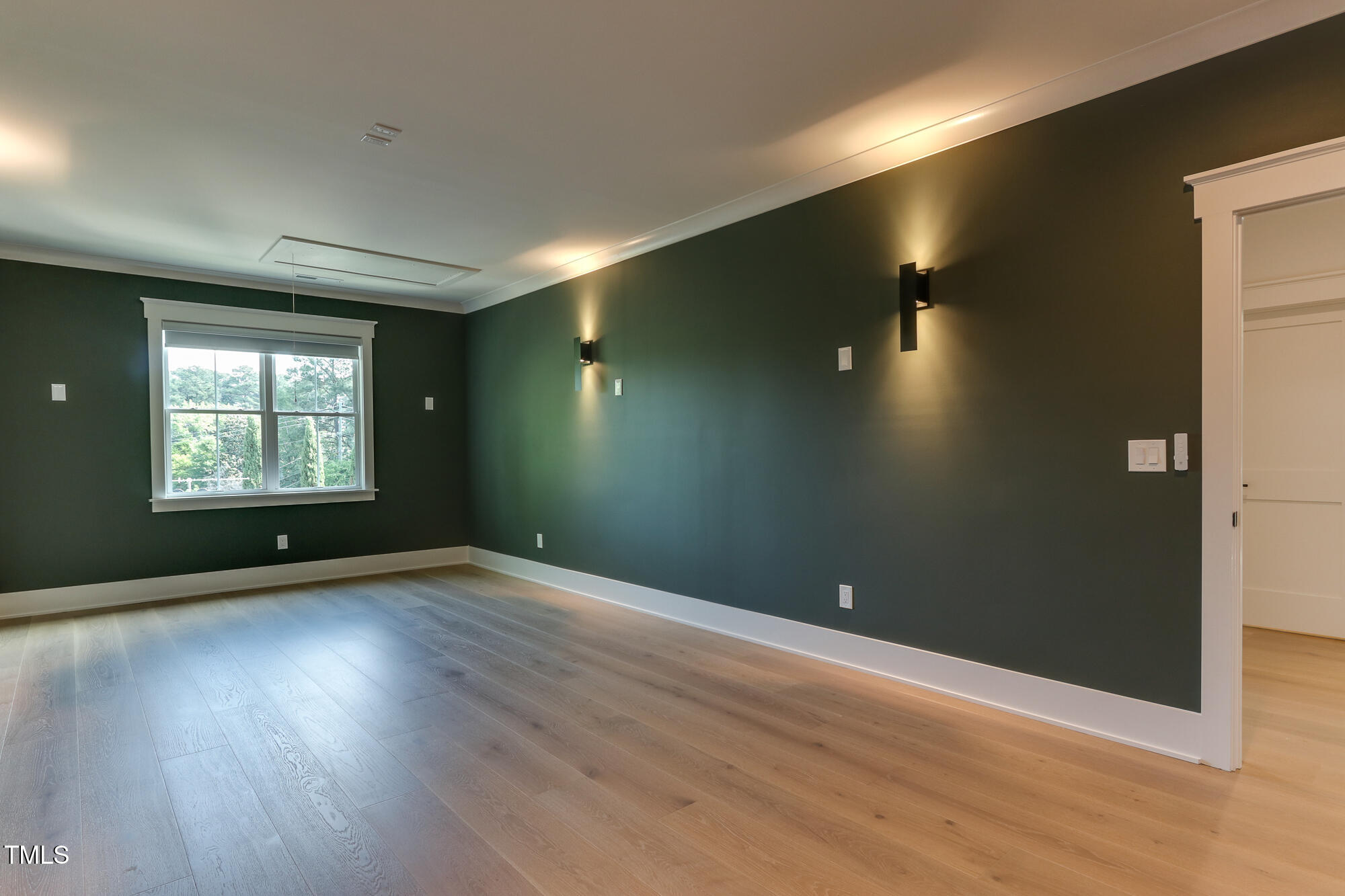 4921 Sweetbriar Drive Raleigh, NC 27609 - Photo 23 of 42 an empty room with wooden floor and windows